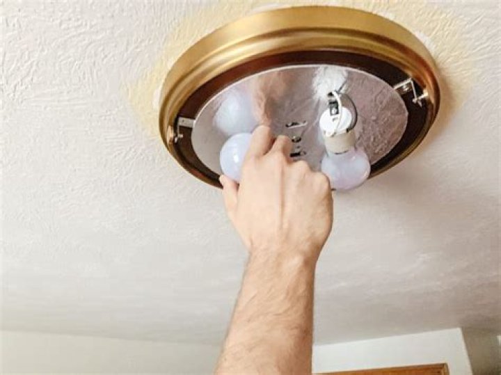 How do you remove a flush mount ceiling light without screws?