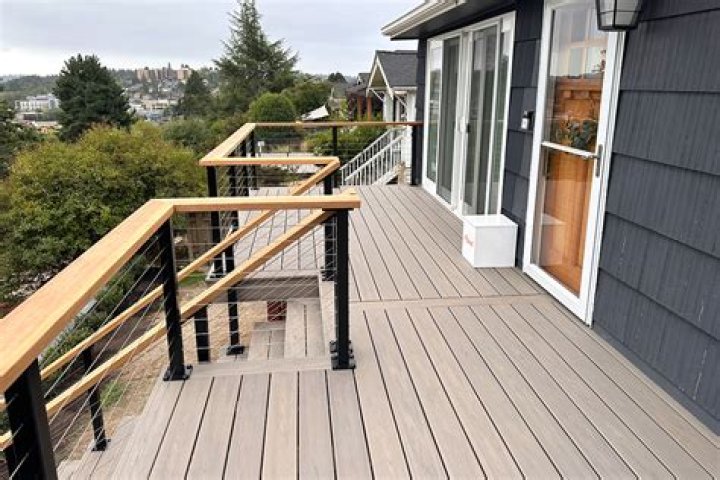 Should a deck railing be attached to the house?